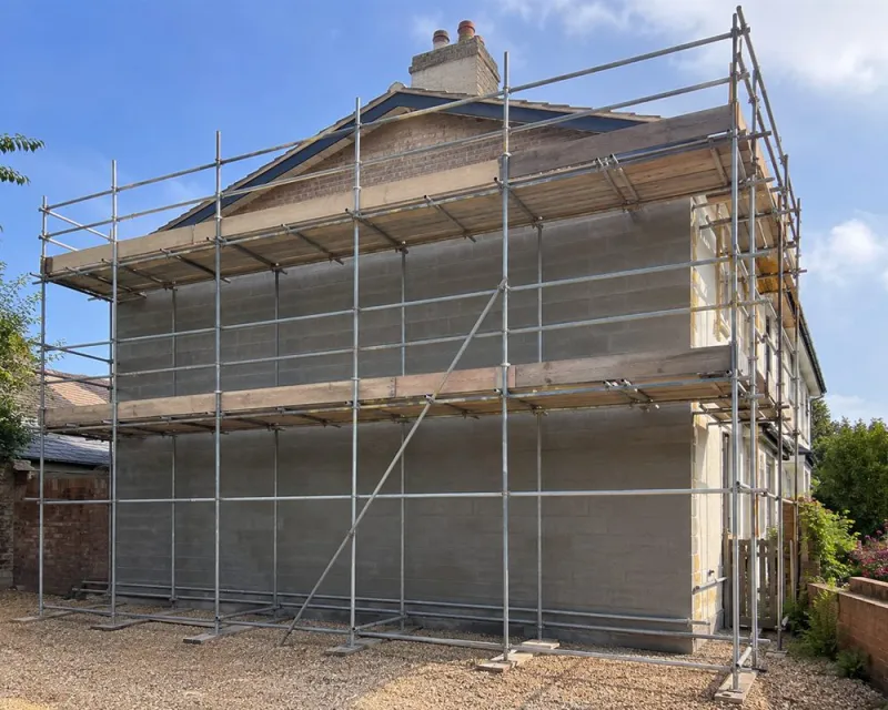 Full-elevation scaffolding set up for rendering work